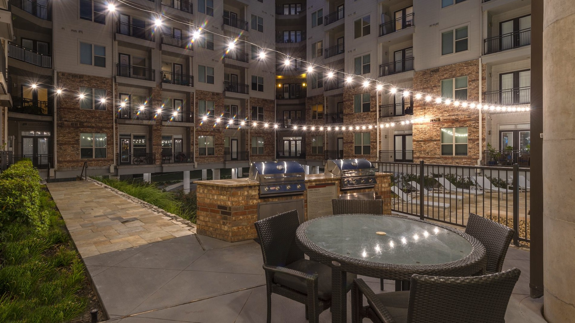 outdoor courtyard area with seating tables and lights