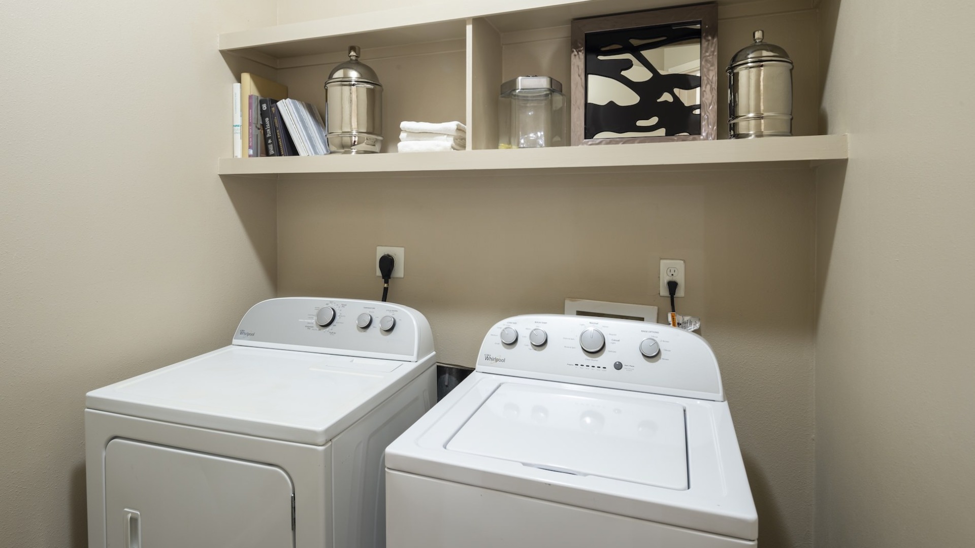 washer and dryer in a closet with shelving