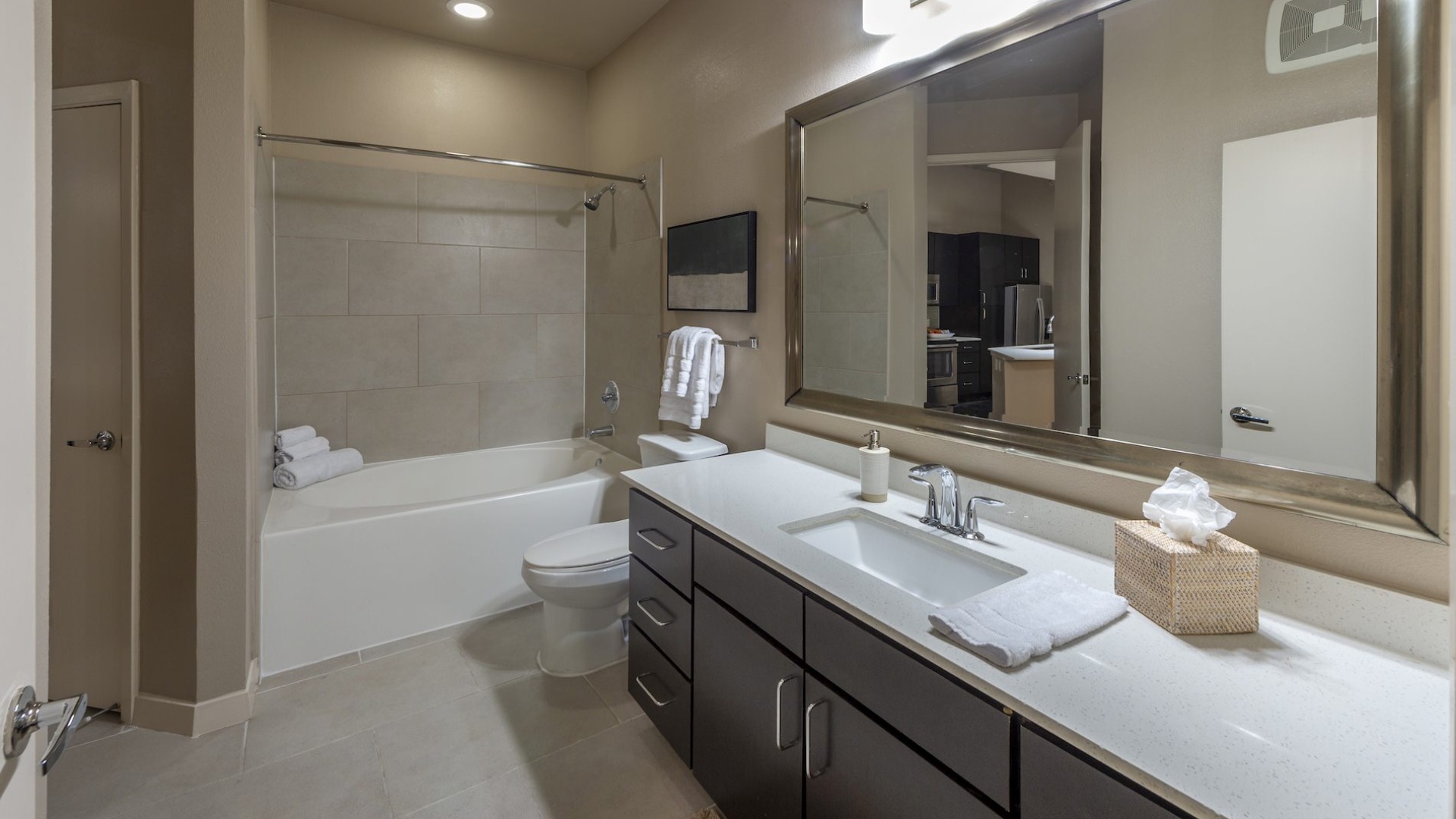 bathroom with a large mirror sink and shower