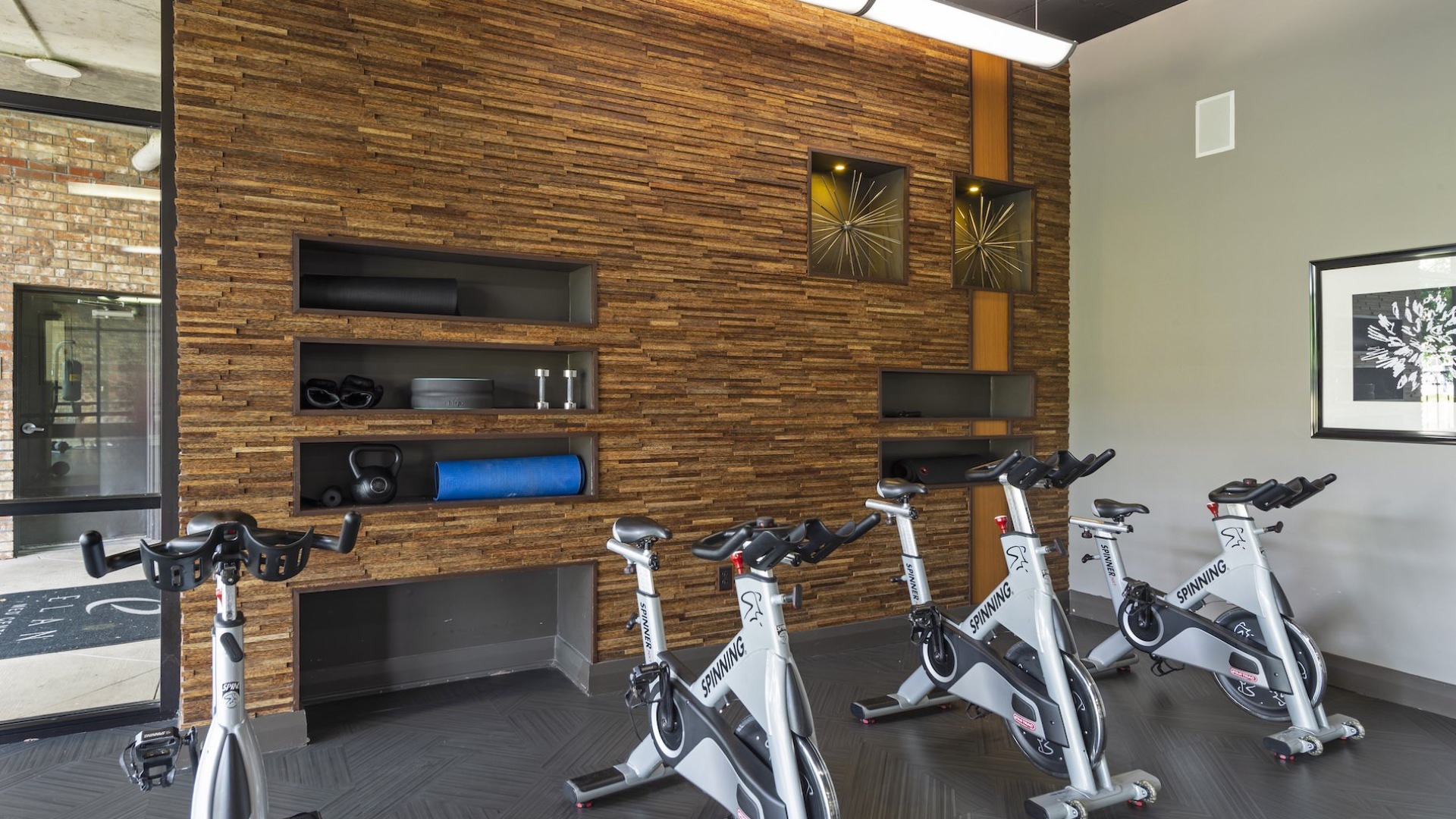 a gym with exercise equipment and tv