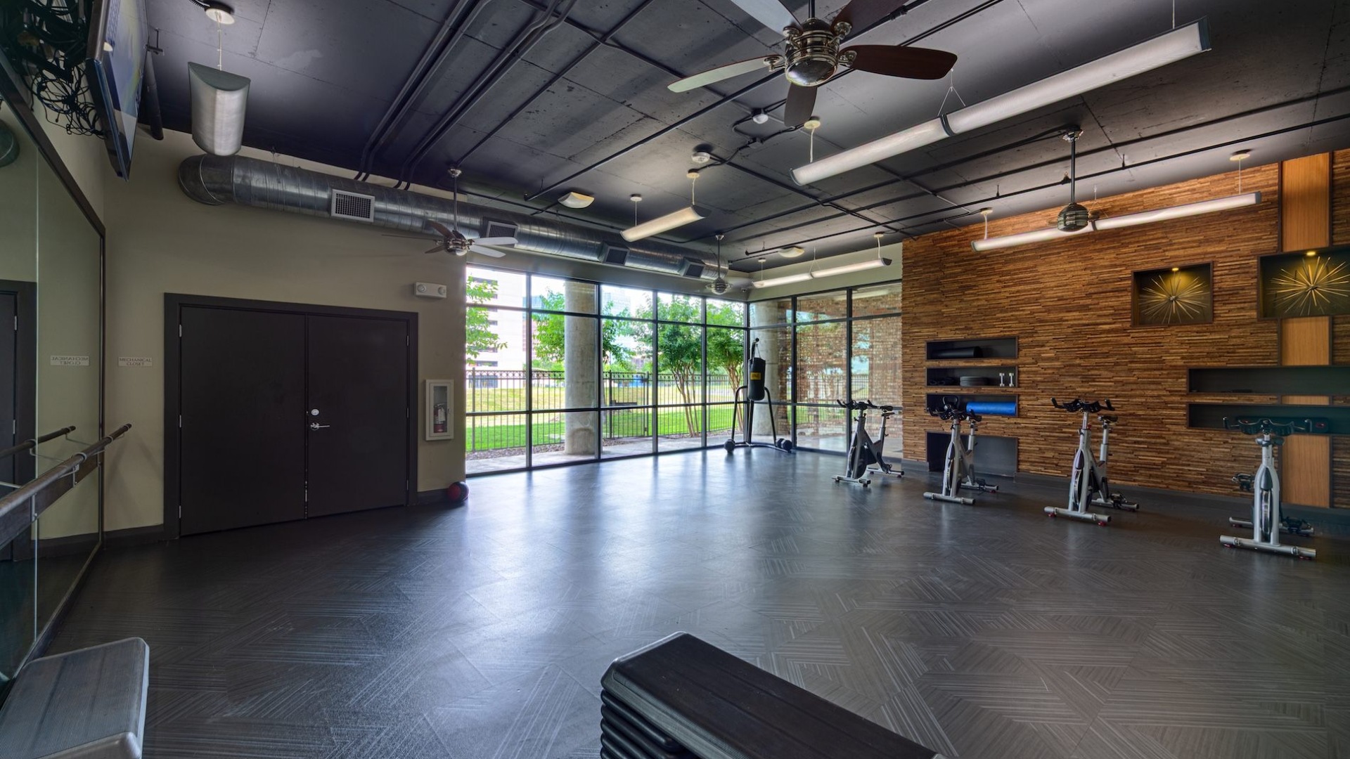 a gym with exercise equipment and tv