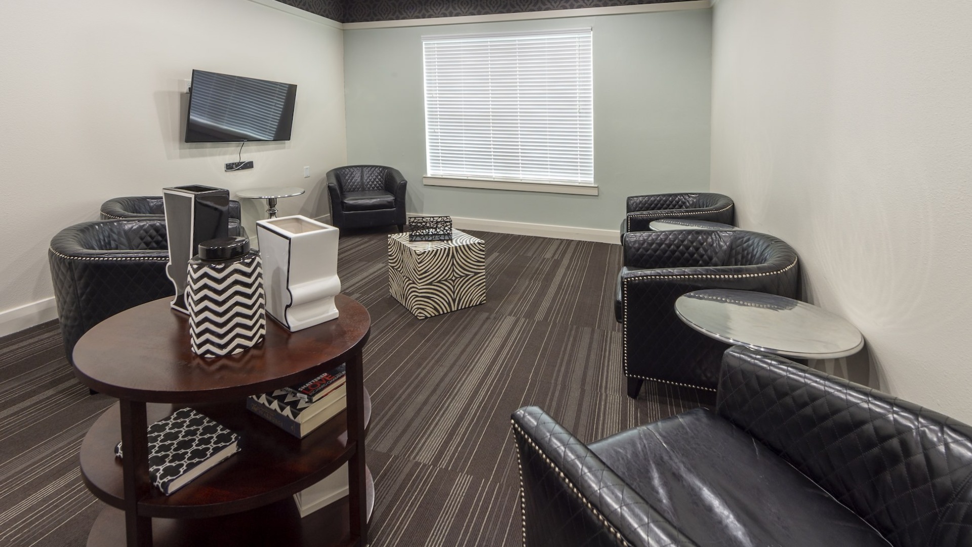 room with seating tables and tv