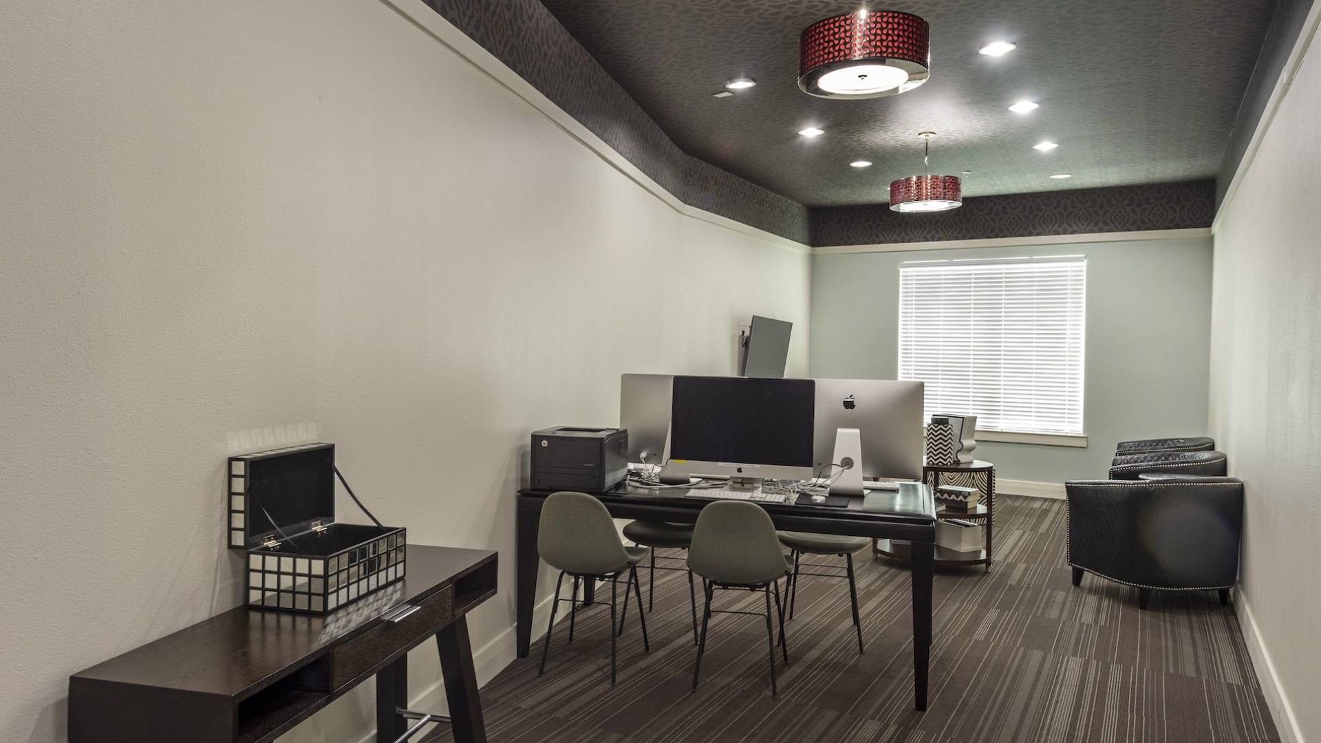 seating area with tables and a computer